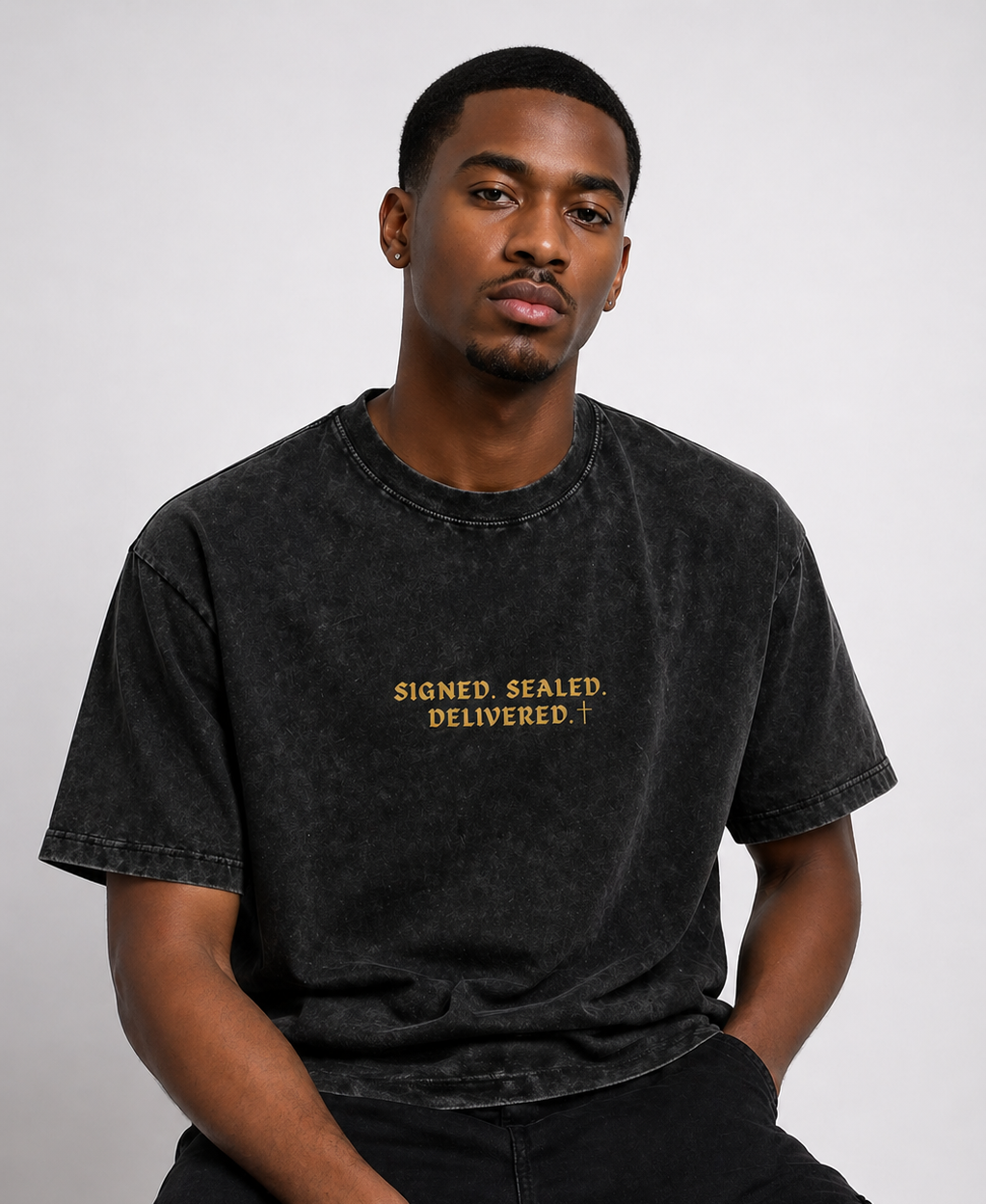 Man wearing a black t-shirt with 'Signed. Sealed. Delivered.' text on a white background